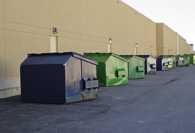 a row of construction dumpsters parked on a jobsite in Pala